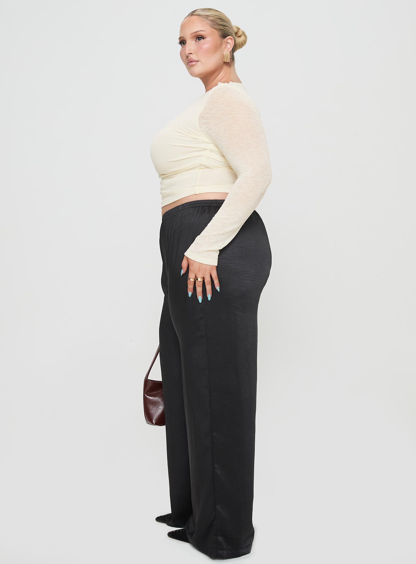 side view of model wearing Princess Polly Nixie Pants Black Curve mid-risedeselected 