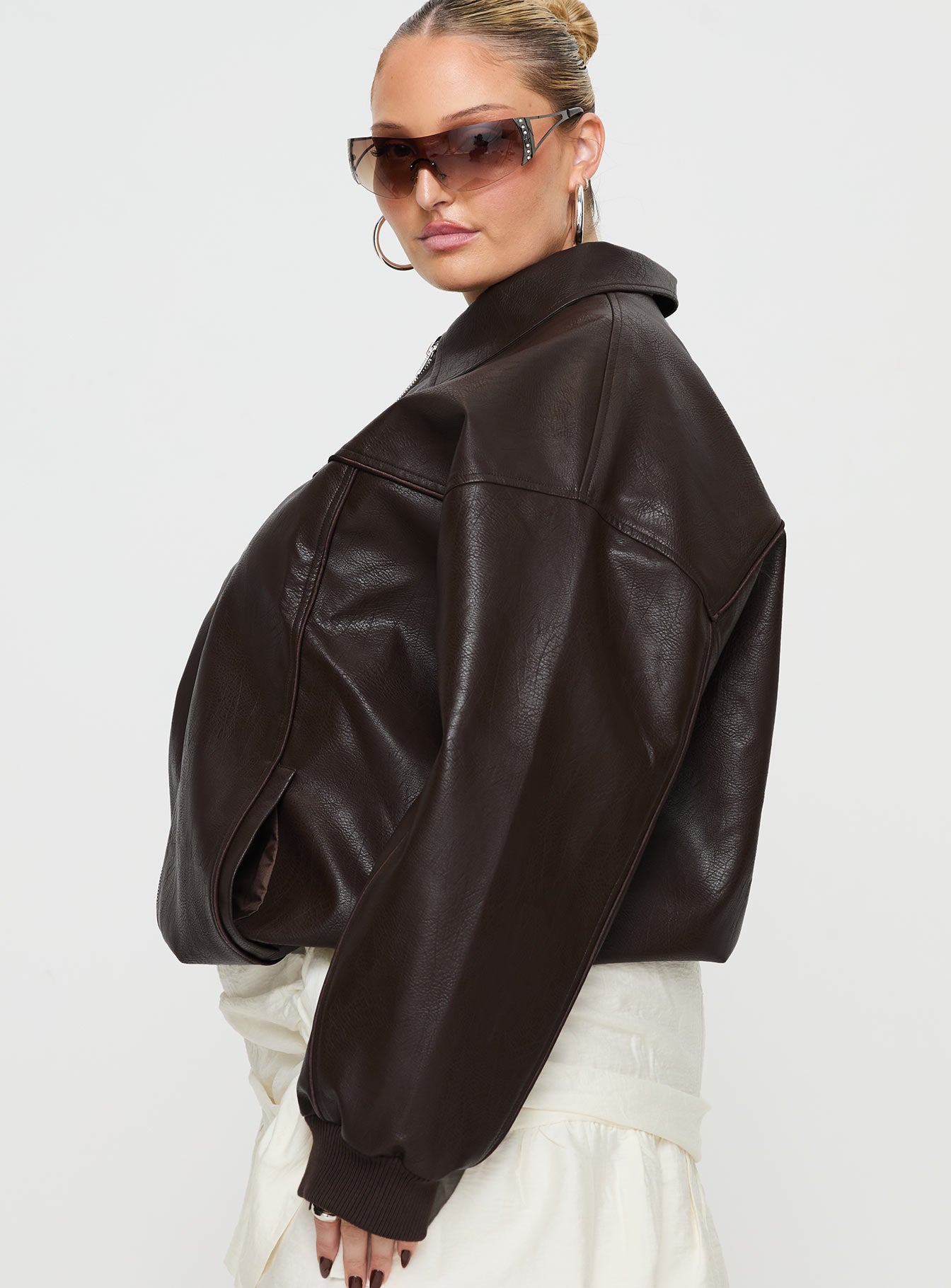 Brown Bomber jacket Oversized fit, faux leather material, classic collar, zip front fastening, ribbed waistband and cuffs, twin hip pockets