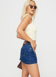   side view of model wearing Princess Polly Nickei Denim Mini Skirt Mid Wash Mini Skirts 