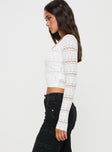 Long sleeve top Slim fitting, sheer knit material, square neck. ribbed cuff and waist