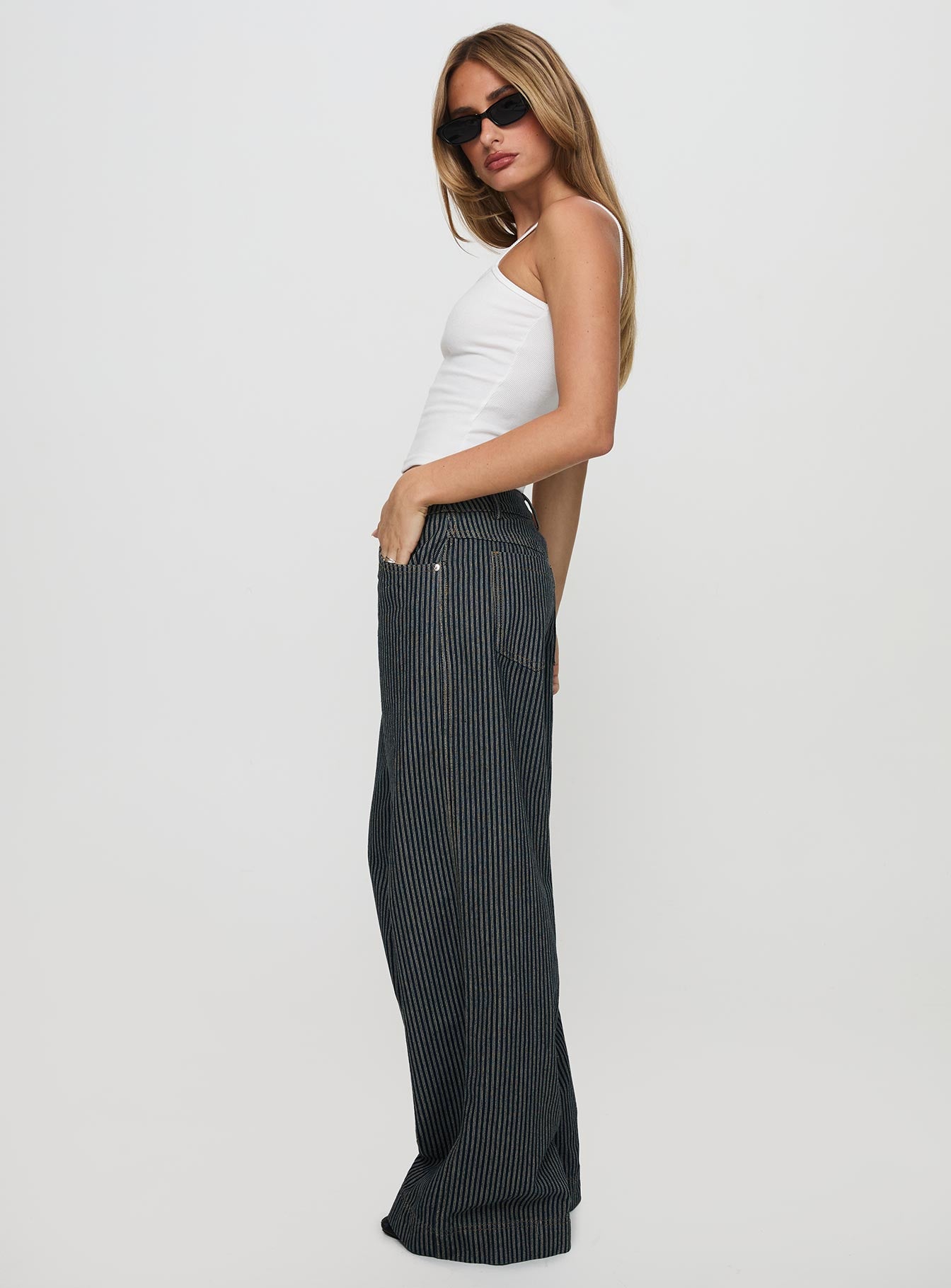 side view of model wearing Princess Polly Actually Invested Low Rise Pants Denim Stripe High Waisted Pants 