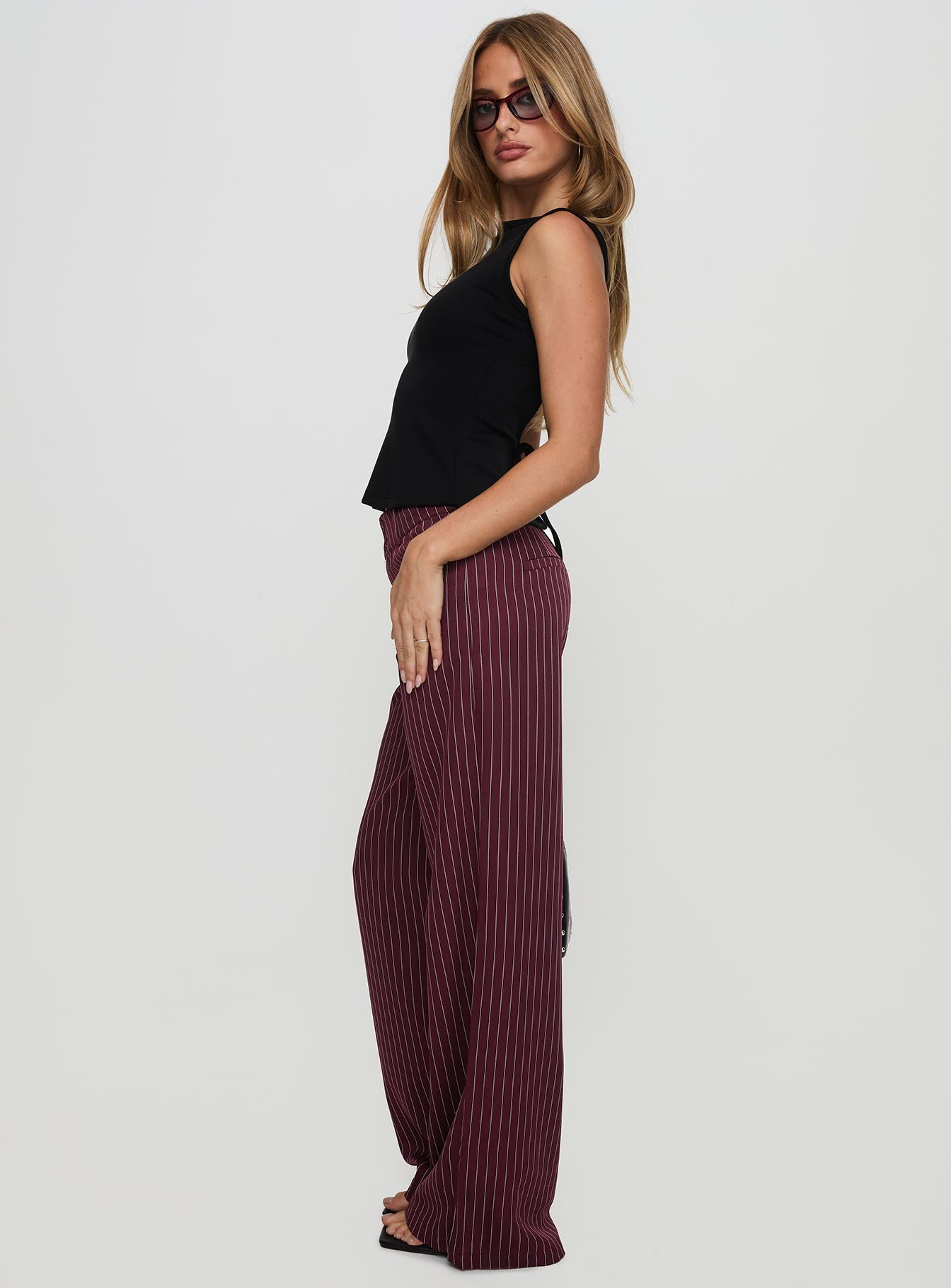 side view of model wearing Princess Polly Lorenne Mid Rise Pant Burgundy Pinstripe High Waisted Pants 