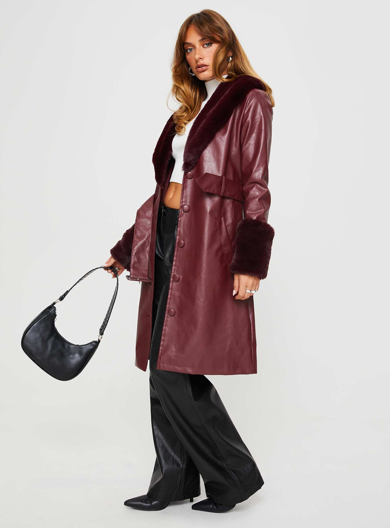 Longline coat Faux leather material, faux fur trimming, button front fastening, twin pockets at sides, removable waist belt