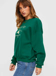 side view of model wearing Princess Polly Apres Ski Crew Neck Sweatshirt Green / Cream 