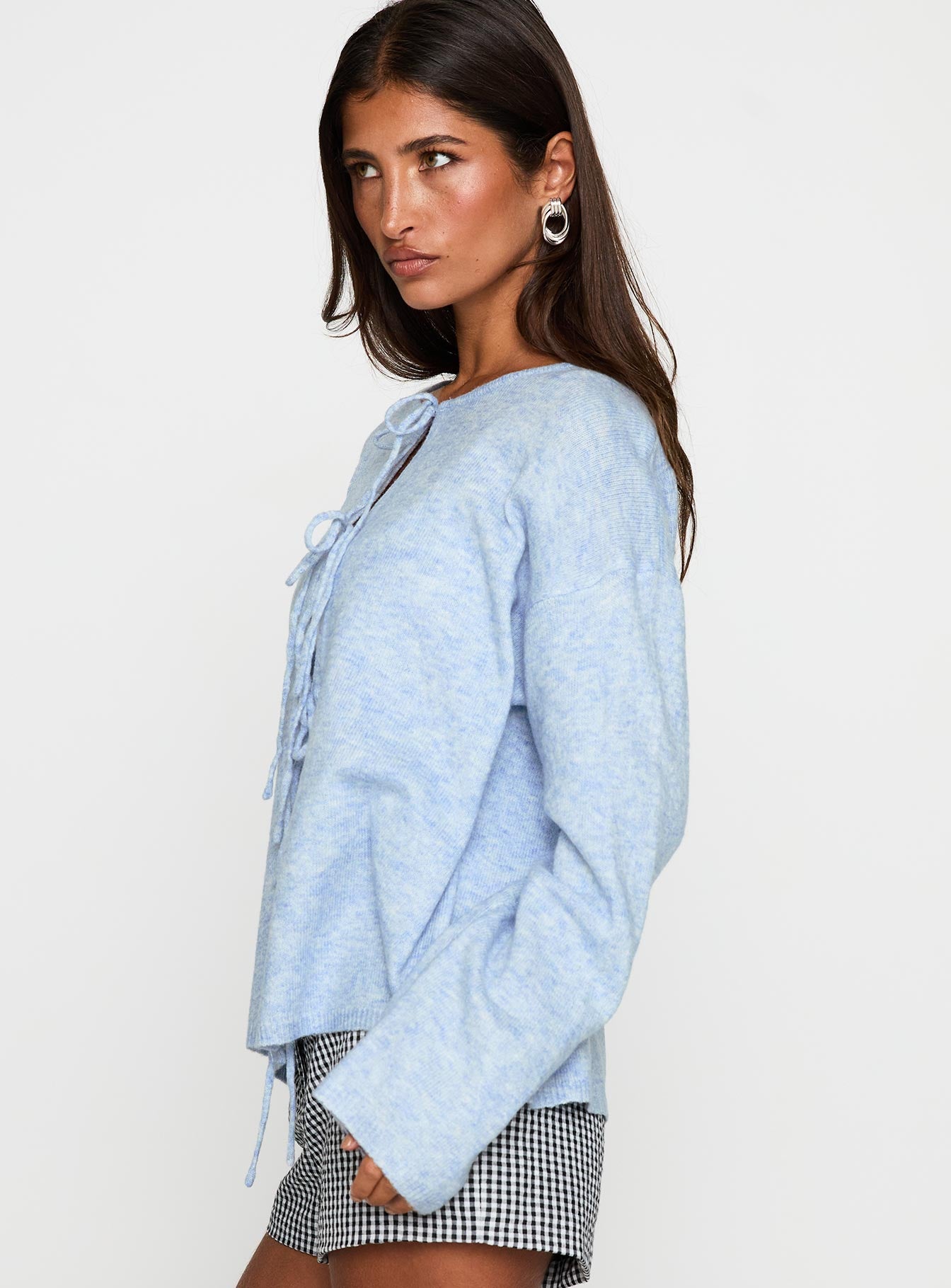 side view of model wearing Princess Polly Frosty Knit Cardigan Blue Long 