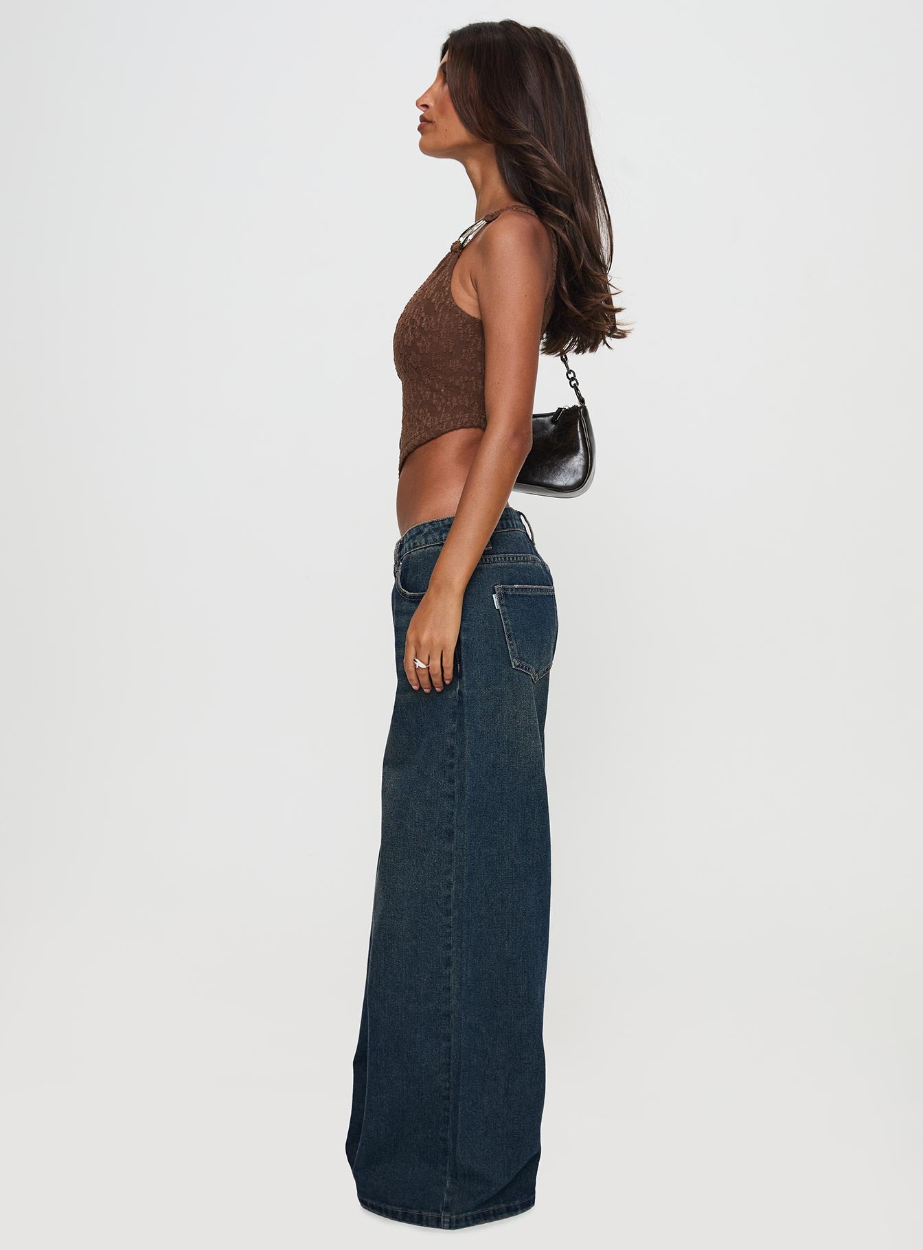 side view of model wearing Princess Polly Low Rise Wide Leg Jean Hocus Pocus Wash Low Rise Jeans 