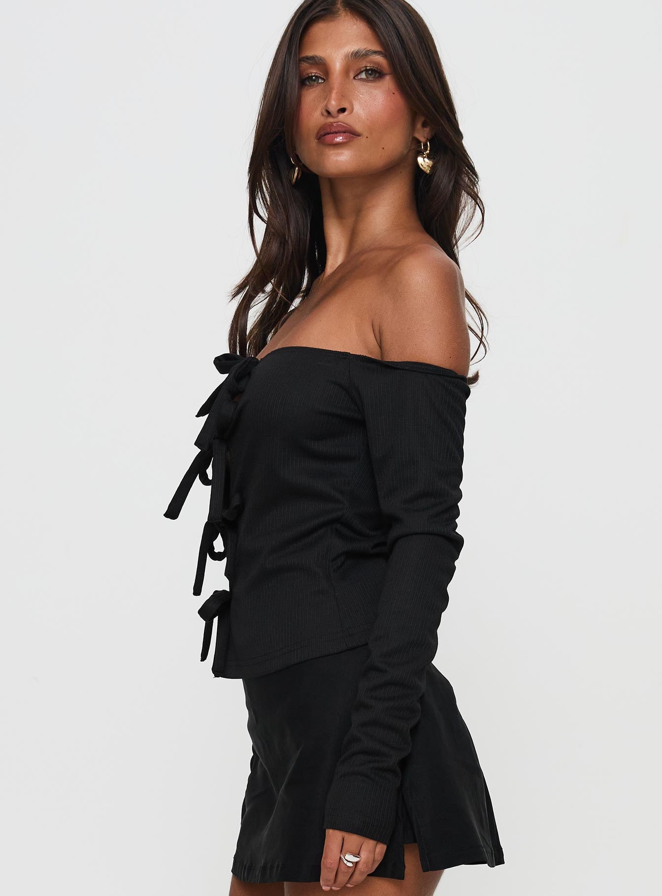 side view of model wearing Princess Polly Wish You The Best Off Shoulder Bow Detail Top Black Sleeveless straight 