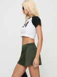   side view of model wearing Princess Polly Caran Cargo Mini Skirt Green Mini Skirts 