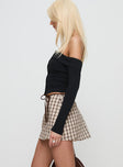 side view of model wearing Princess Polly Korren Low Rise Skort Plaid Low Rise Shorts 