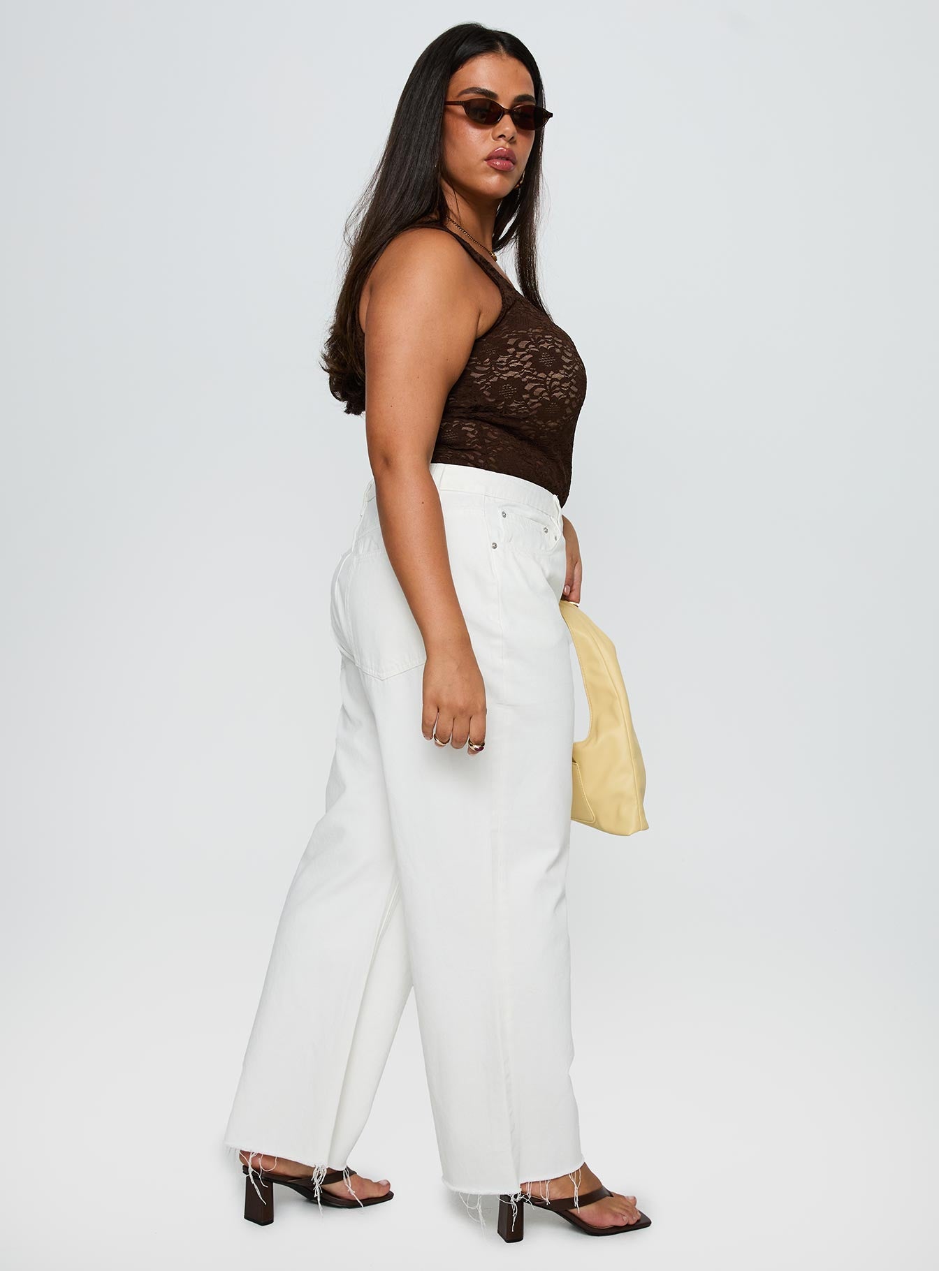 side view of model wearing Princess Polly Fawcett Jeans White Curve High Waisted 