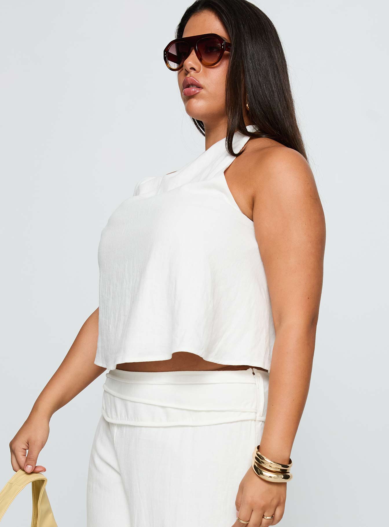side view of model wearing Princess Polly Aquaria Halter Linen Blend Top White Curve Sleeveless Crew Neck 