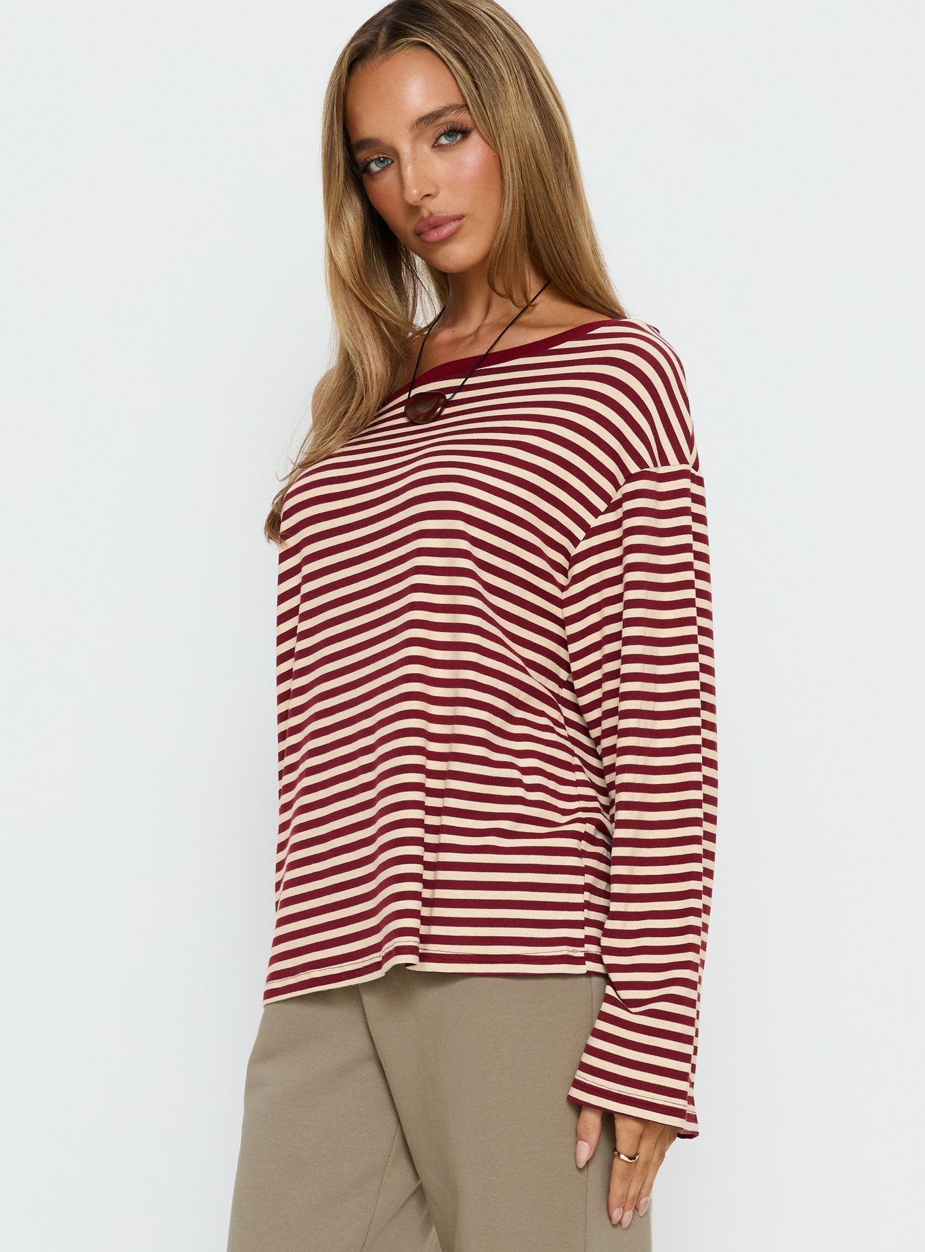 side view of model wearing Princess Polly Ralyssa Off Shoulder Long Sleeve Top Red Stripe Longline Jumpers 
