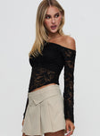 side view of model wearing Princess Polly Soffie Off Shoulder Lace Long Sleeve Top Black Full Sleeves Asymmetric Neckline 