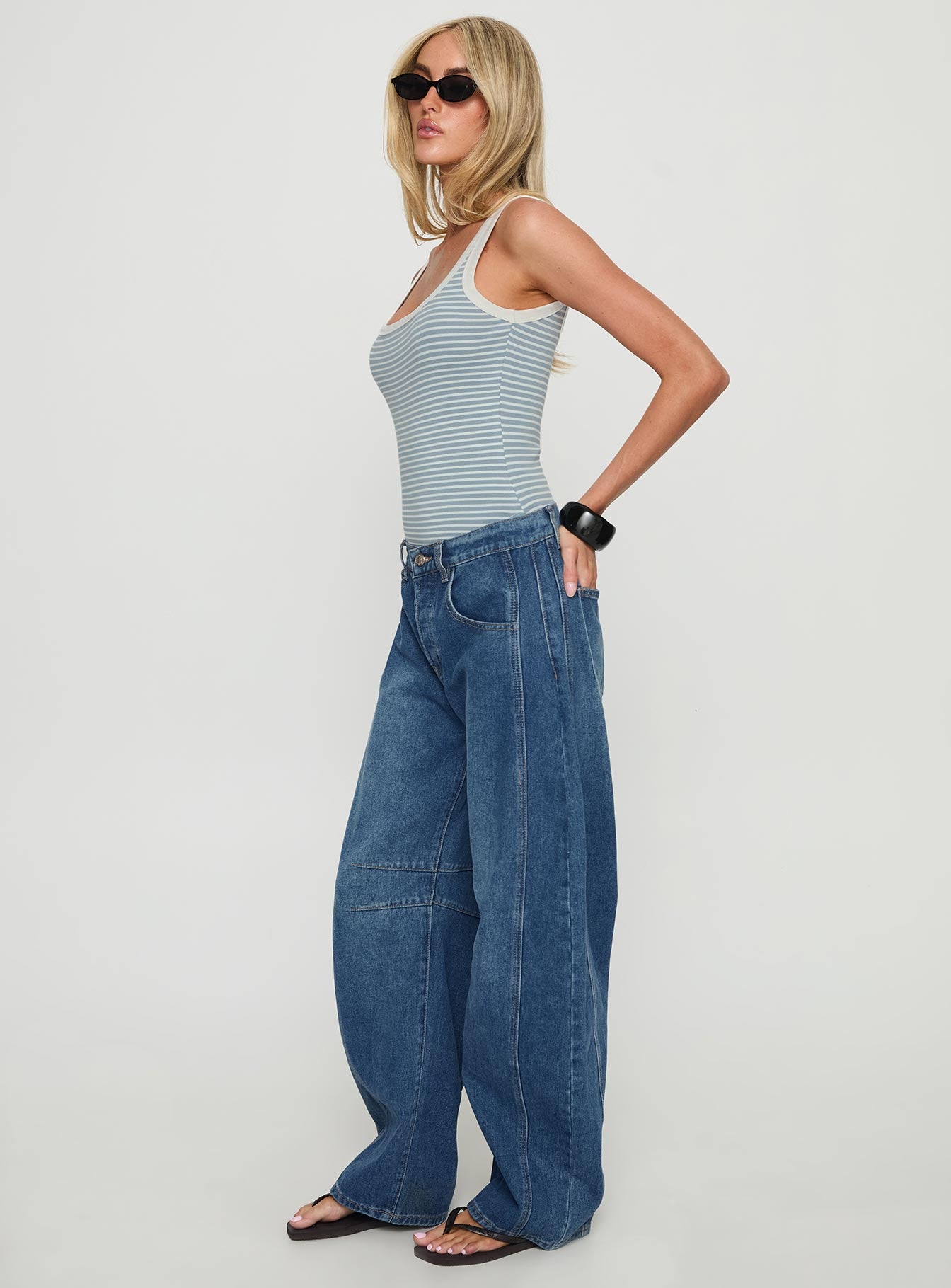 side view of model wearing Princess Polly Normana Mid Rise Cropped Barrel Jeans Mid Blue Wash Mid Rise Jeans 