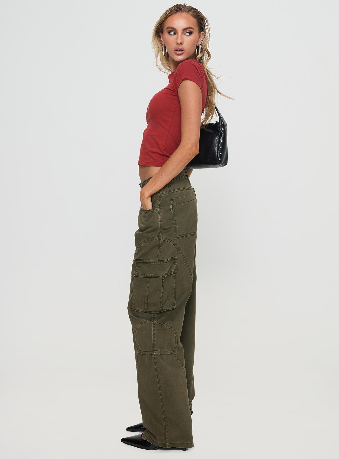 side view of model wearing Princess Polly Ahstin Cargo Jeans Green Low Rise Jeans 