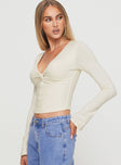 side view of model wearing Princess Polly Ophelie Top Cream Full Sleeves V-Neck 