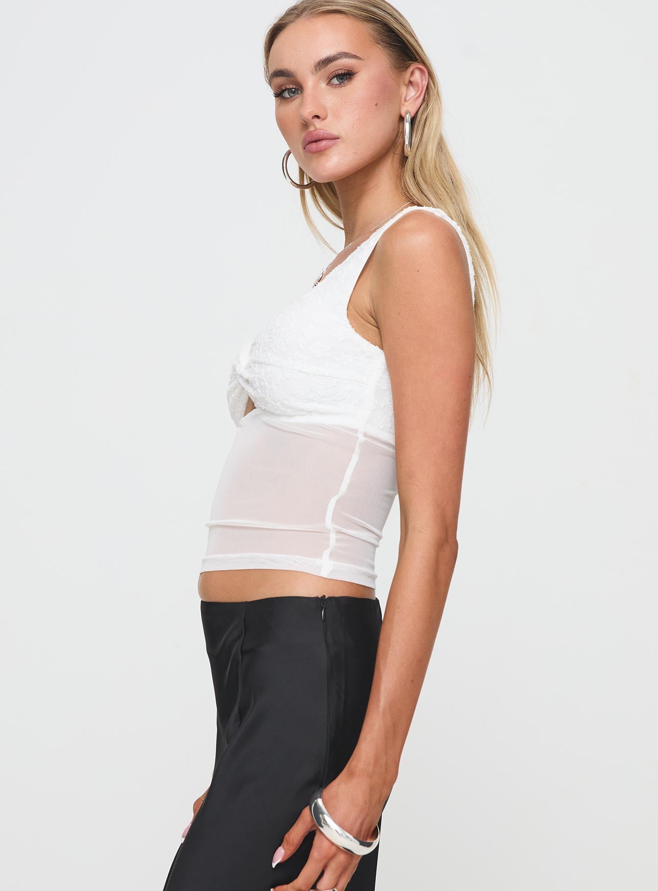 side view of model wearing Princess Polly Gita Top White Sleeveless Sweetheart 