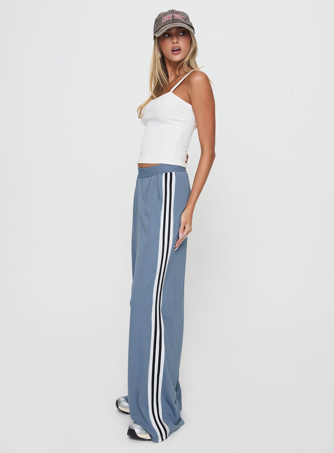 side view of model wearing Princess Polly Dime Track Pants Blue High Waisted Pants 