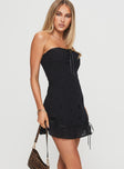 side view of model wearing Princess Polly Molloy Strapless Mini Dress Black Straight Neck 