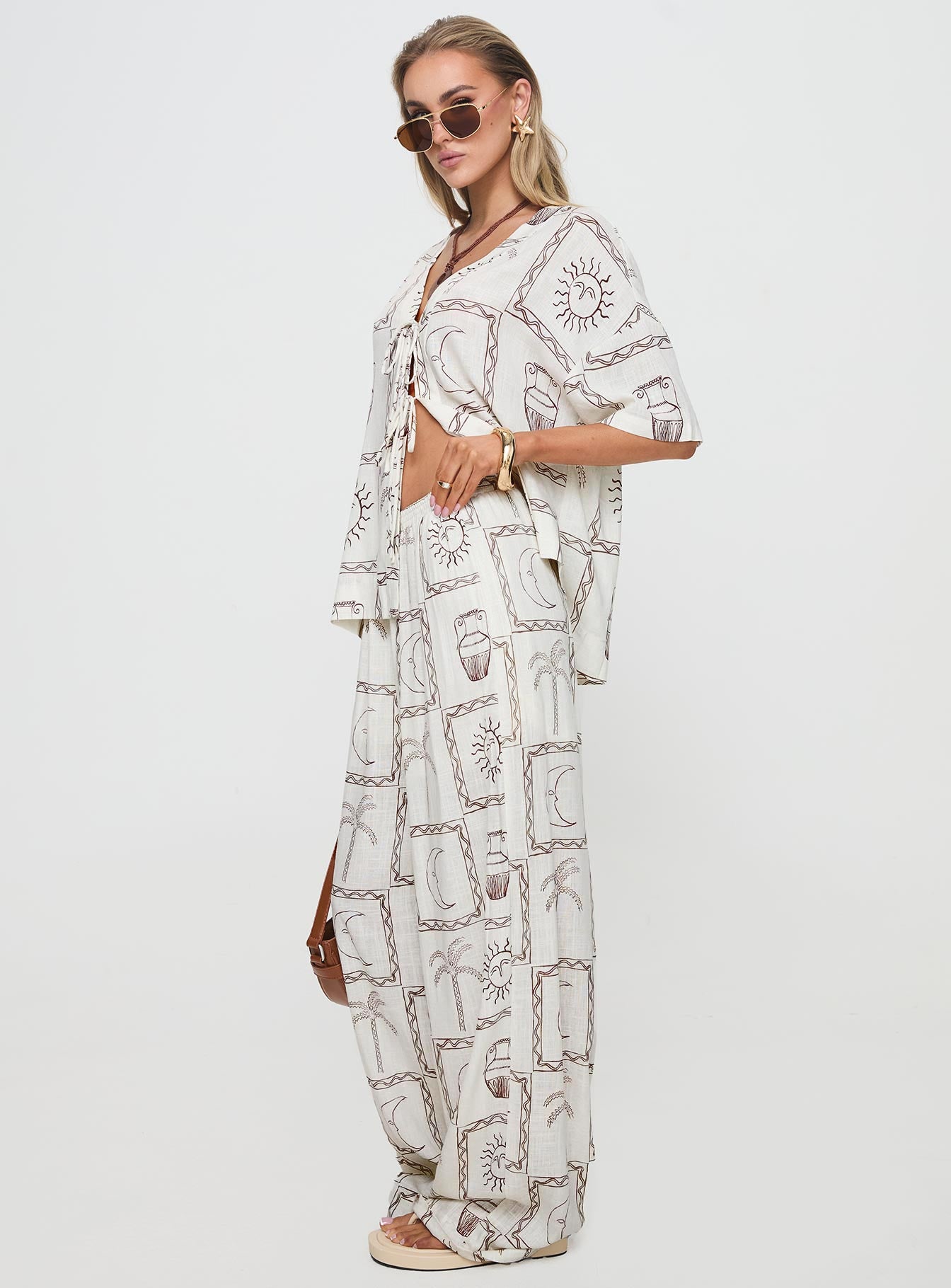 side view of model wearing Princess Polly Sun Dream Pants Cream / Multi High Waisted Pants 