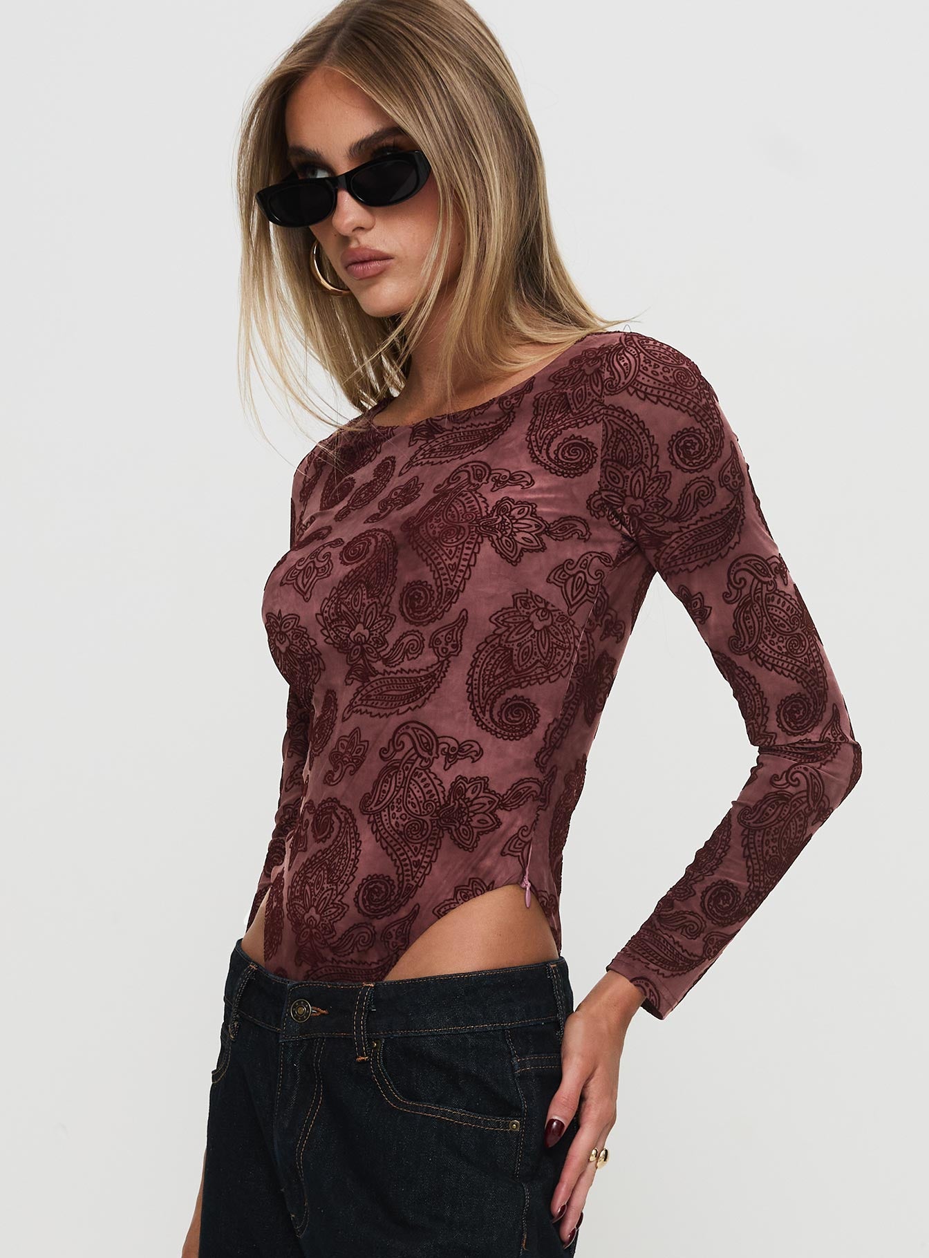 side view of model wearing Princess Polly Spruce Bodysuit Red Paisley Long Sleeve Tops 