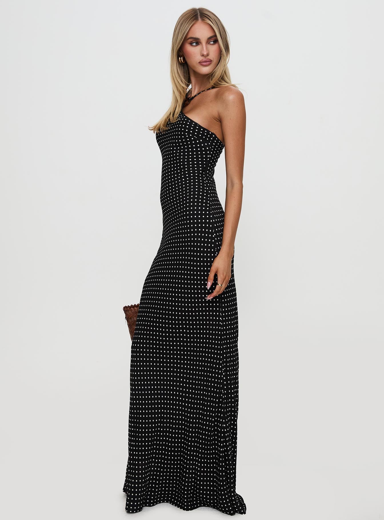 side view of model wearing Princess Polly Evyn Halter Maxi Dress Polka Dot Asymmetric Neckline 