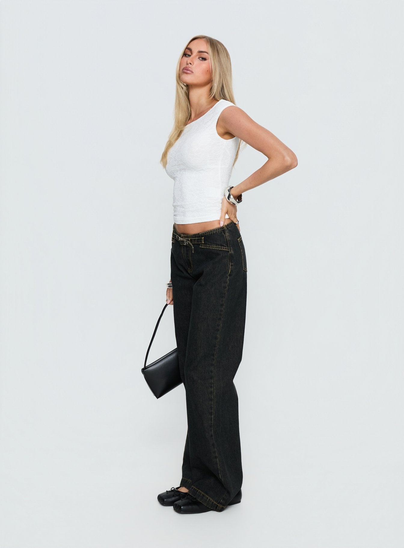 side view of model wearing Princess Polly Slow Ride Mid Rise Bootleg Belted Jeans Grunge Wash Mid Rise Jeans 
