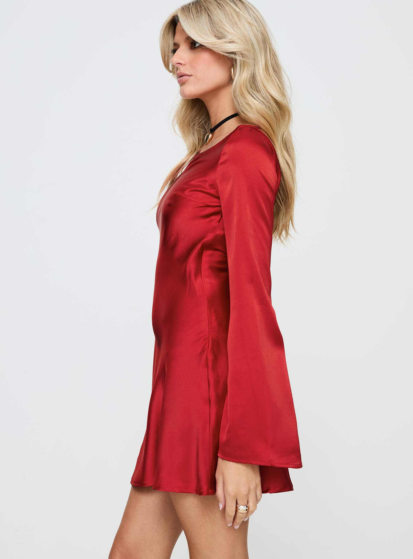 side view of model wearing Princess Polly Lukea Long Sleeve Satin Mini Dress Red Boat Neck 