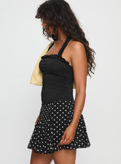   side view of model wearing Princess Polly Godet Mini Skirt Black / White Polka Mini Skirts 