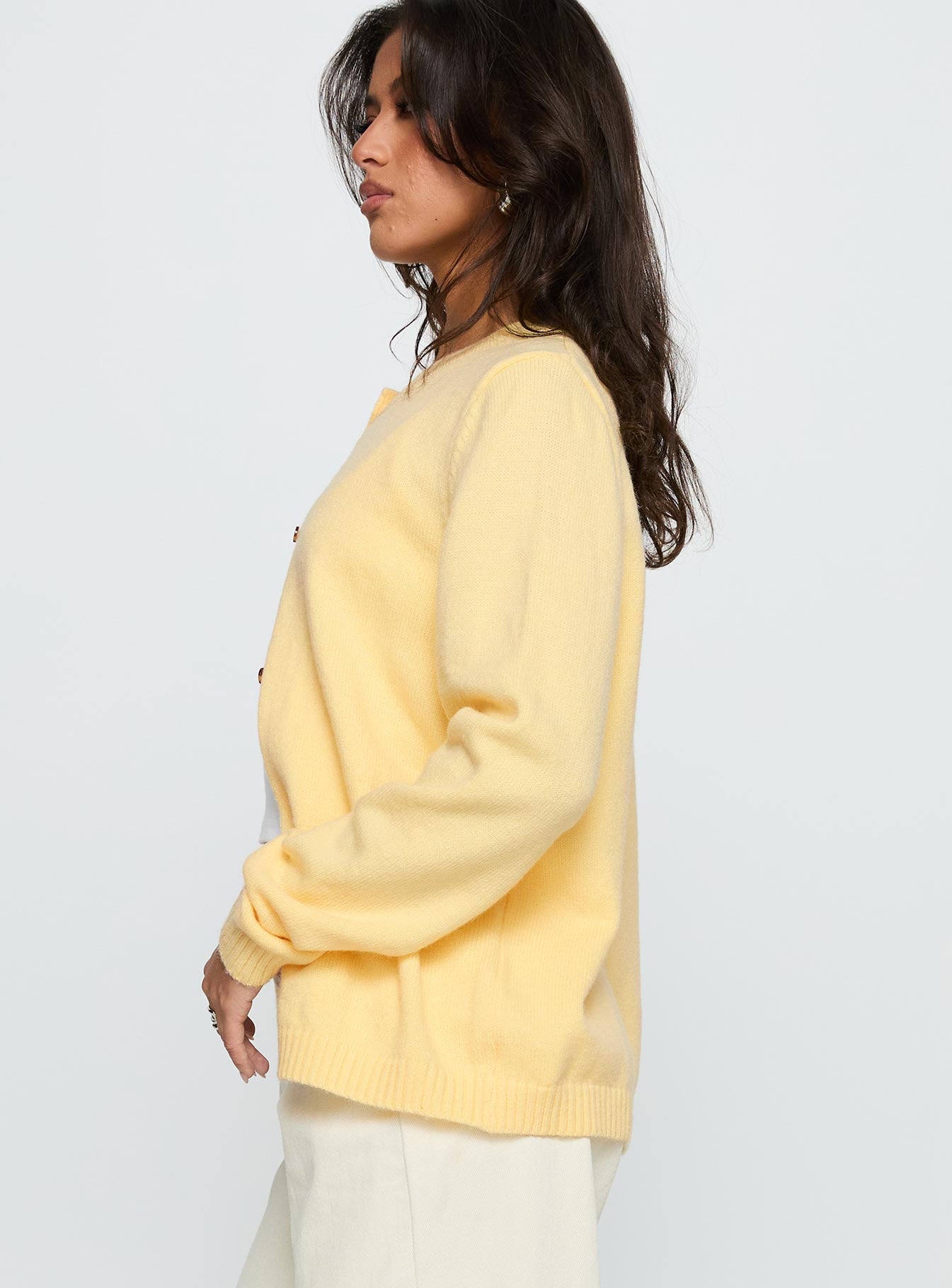 side view of model wearing Princess Polly Arica Button Up Knit Cardigan Lemon Long 