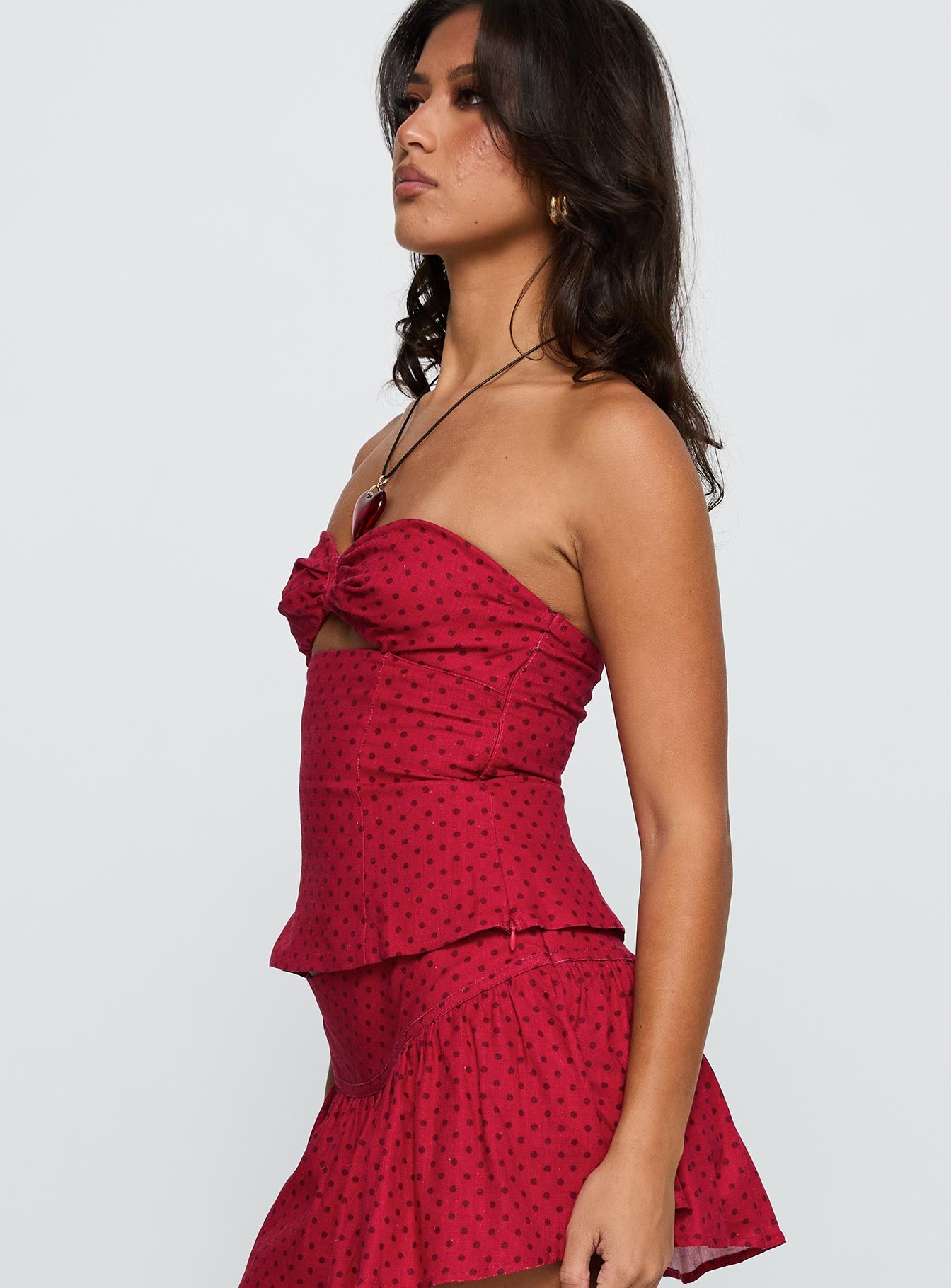 side view of model wearing Princess Polly Kandee Twist Linen Blend Top Red Polka Sleeveless Sweetheart 