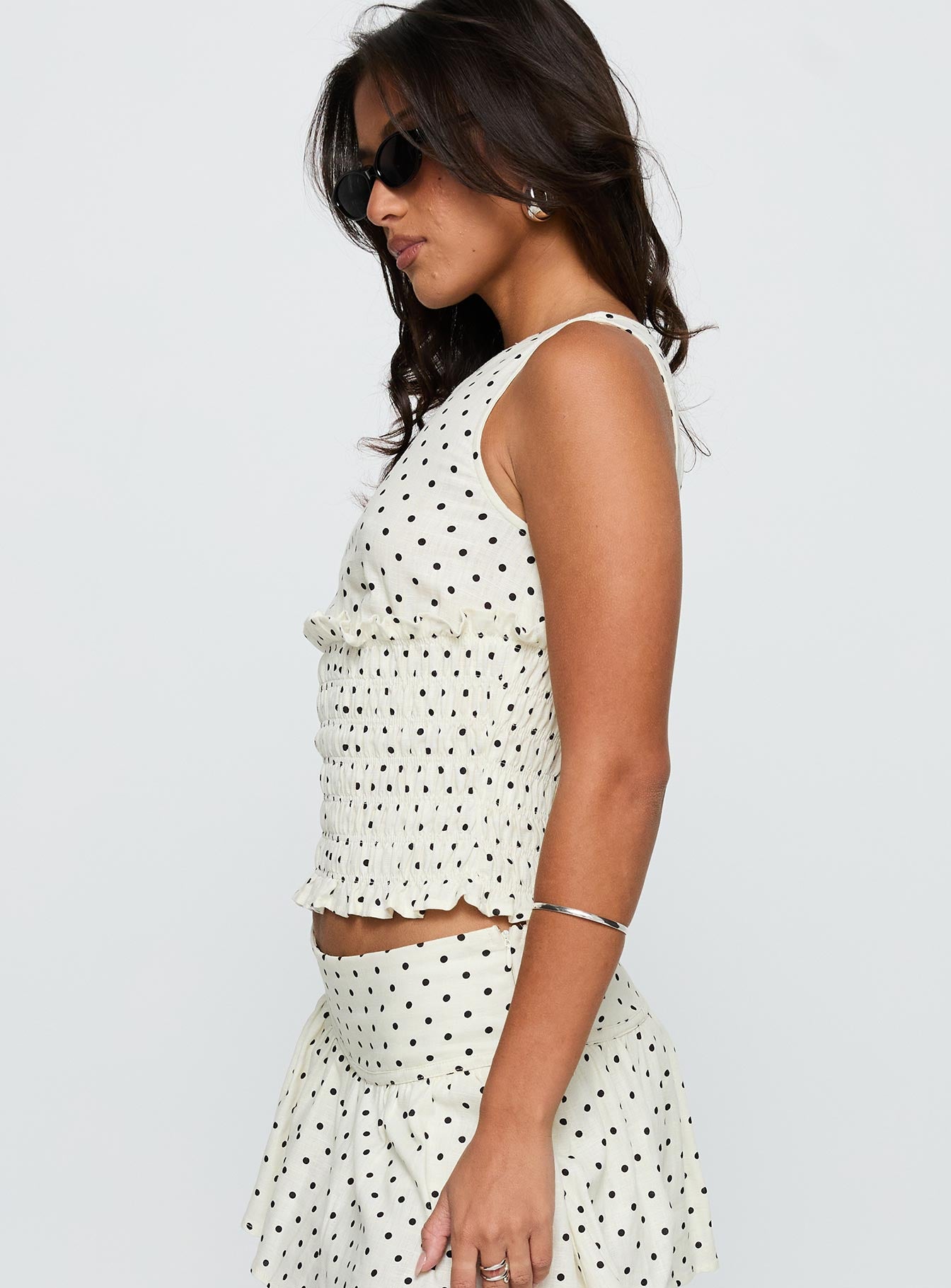 side view of model wearing Princess Polly Roxee Ruched Linen Blend Top Cream Polka Sleeveless Boat Neck 