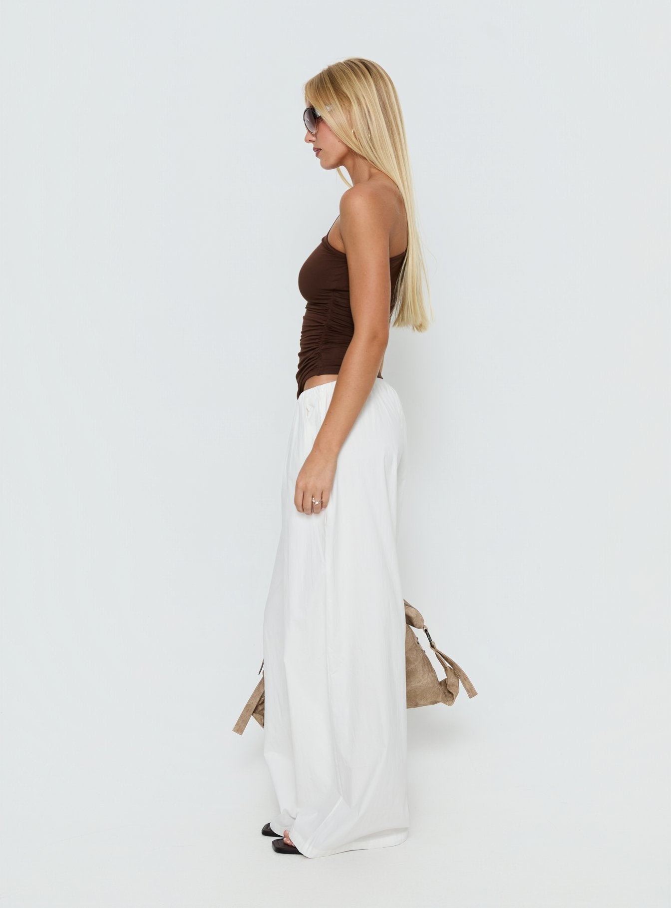 side view of model wearing Princess Polly Lunea Concealed Waistband Pants White Low Rise Pants 