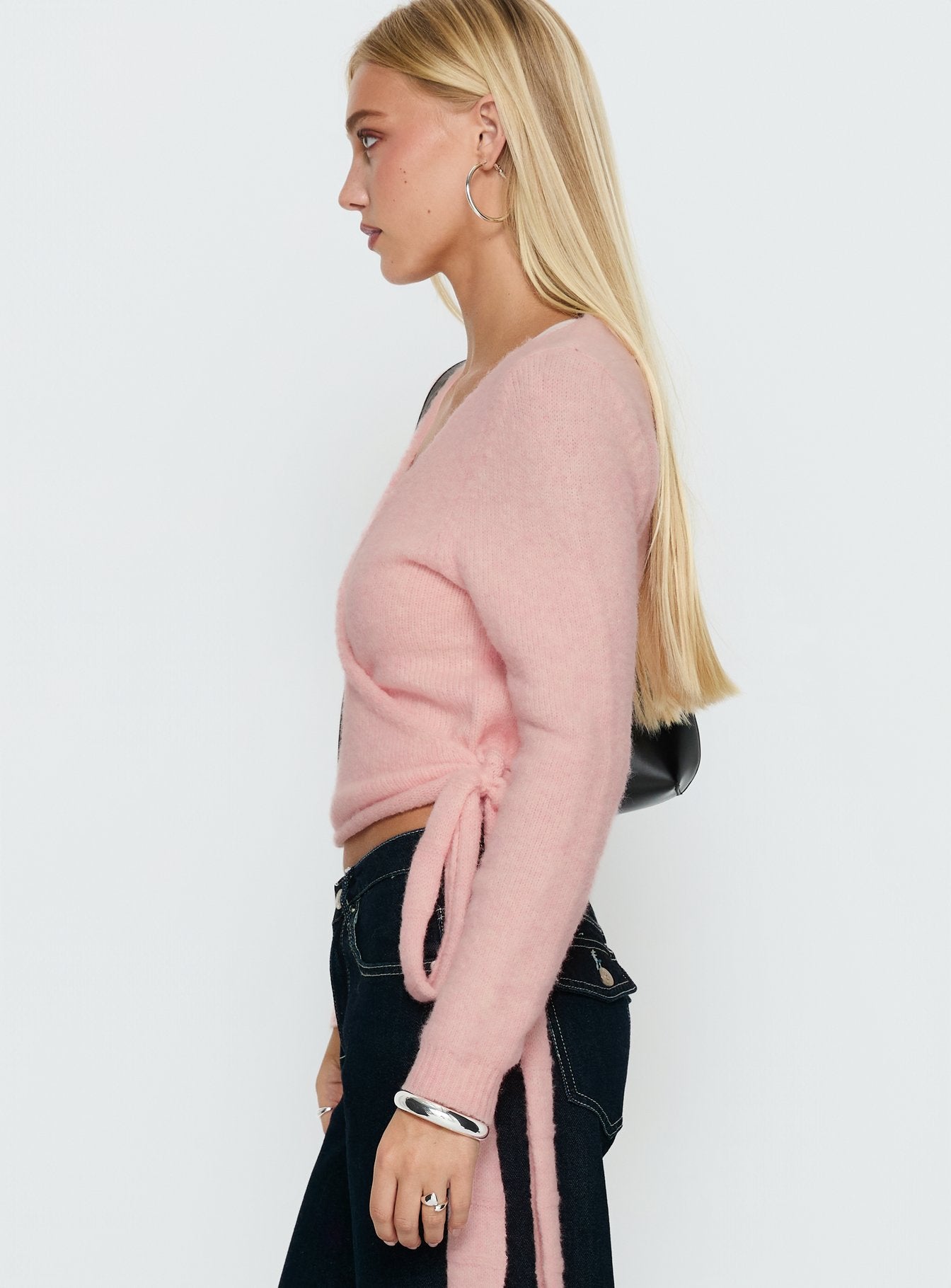 side view of model wearing Princess Polly Tonee Wrap Knit Cardigan Pink cropped 