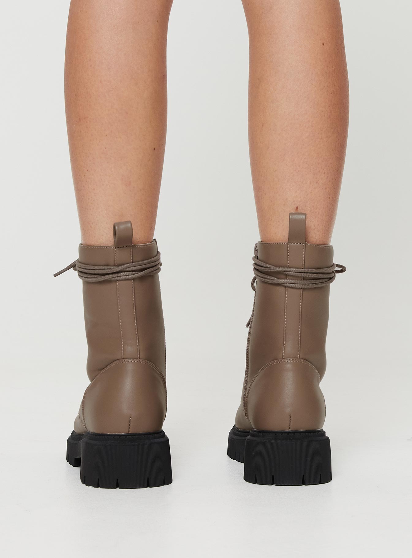 Faux leather boot Lace up fastening, rounded toe, pull tab at back, platform base, padded footbed