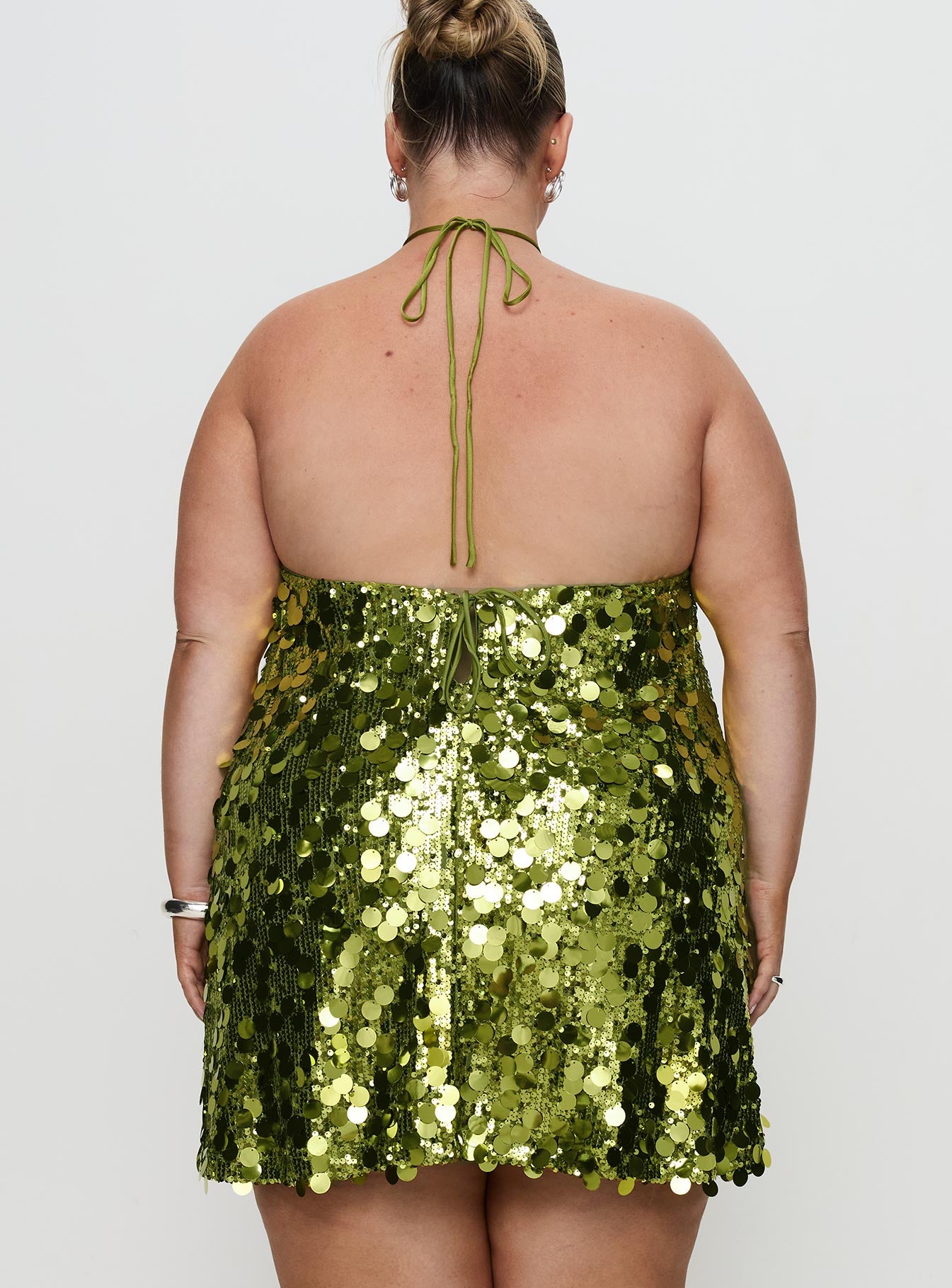back view of model wearing Princess Polly Fluorescents Halter Mini Dress Green Curve Asymmetric Neckline 