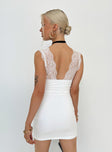 White mini dress Lace material  Plunging neckline Good stretch Partially lined