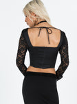 Black long sleeve top Silk and lace material Sweetheart neckline Zip fastening at back Boning throughout Tie fastening at back