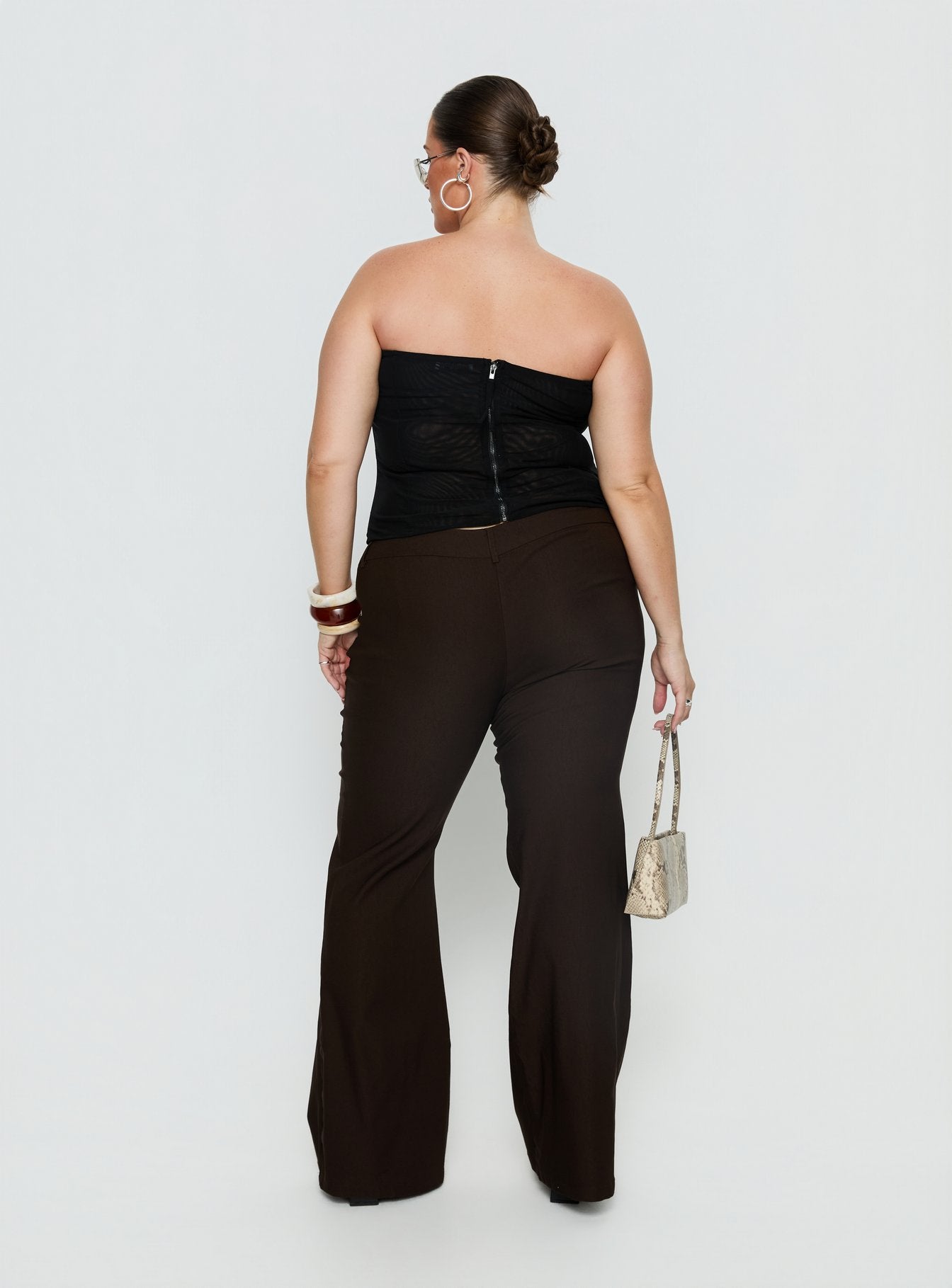 back view of model wearing Princess Polly Kinkirk Flared Pants Chocolate Curve Mid Rise Pants 