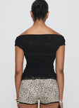 back view of model wearing Princess Polly Sonnie Off Shoulder Top Black Short Sleeves Cowl 