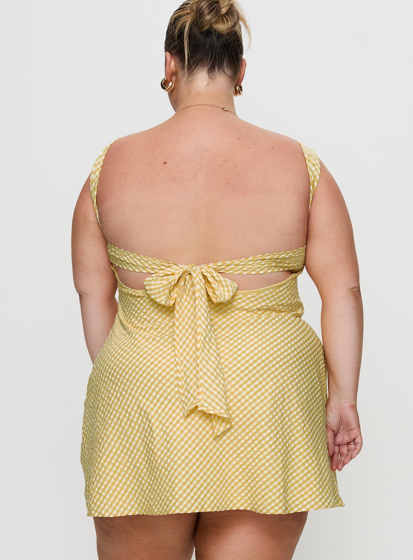 back view of model wearing Princess Polly Mcbeath Mini Dress Yellow Curve Sweetheart Neckline 