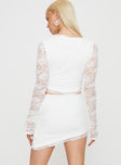 White Matching lace set Long sleeve top tie fastening at bust ruffle detail Mid rise mini skirt asymmetric hem