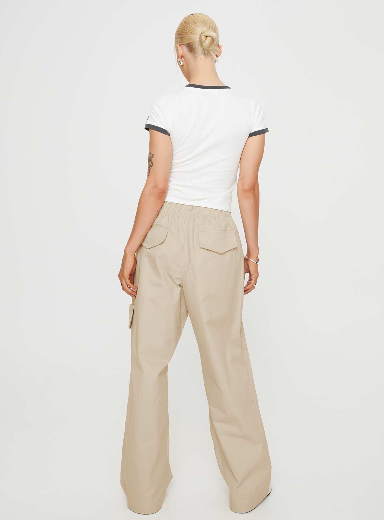 Front view of model wearing  front Princess Polly High Waisted Pants  Isadore Cargo Pants Beige