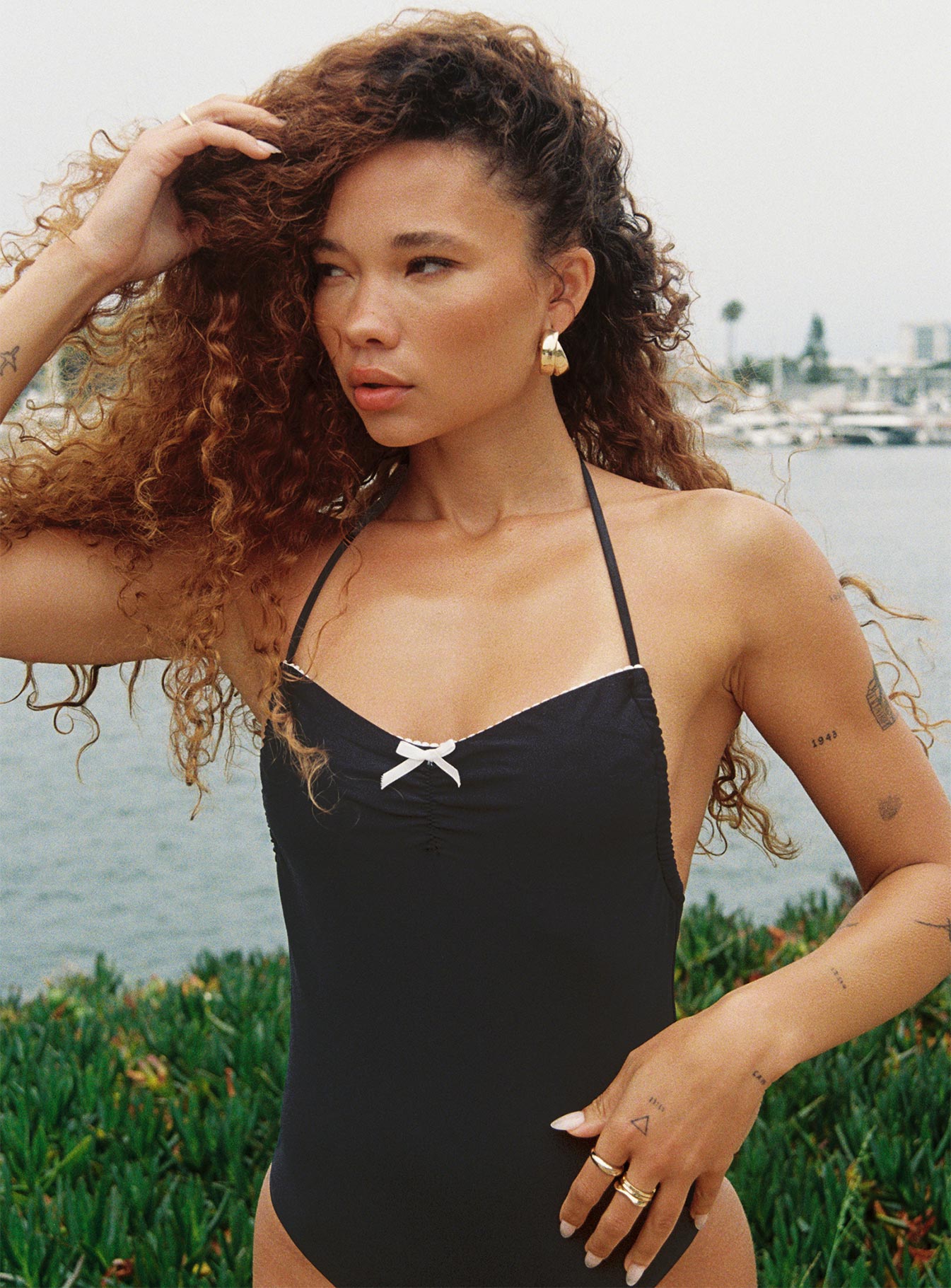 Strapless one piece Halter tie fastening  Adjustable coverage High cut leg Removable padding Low back Brief style bottom