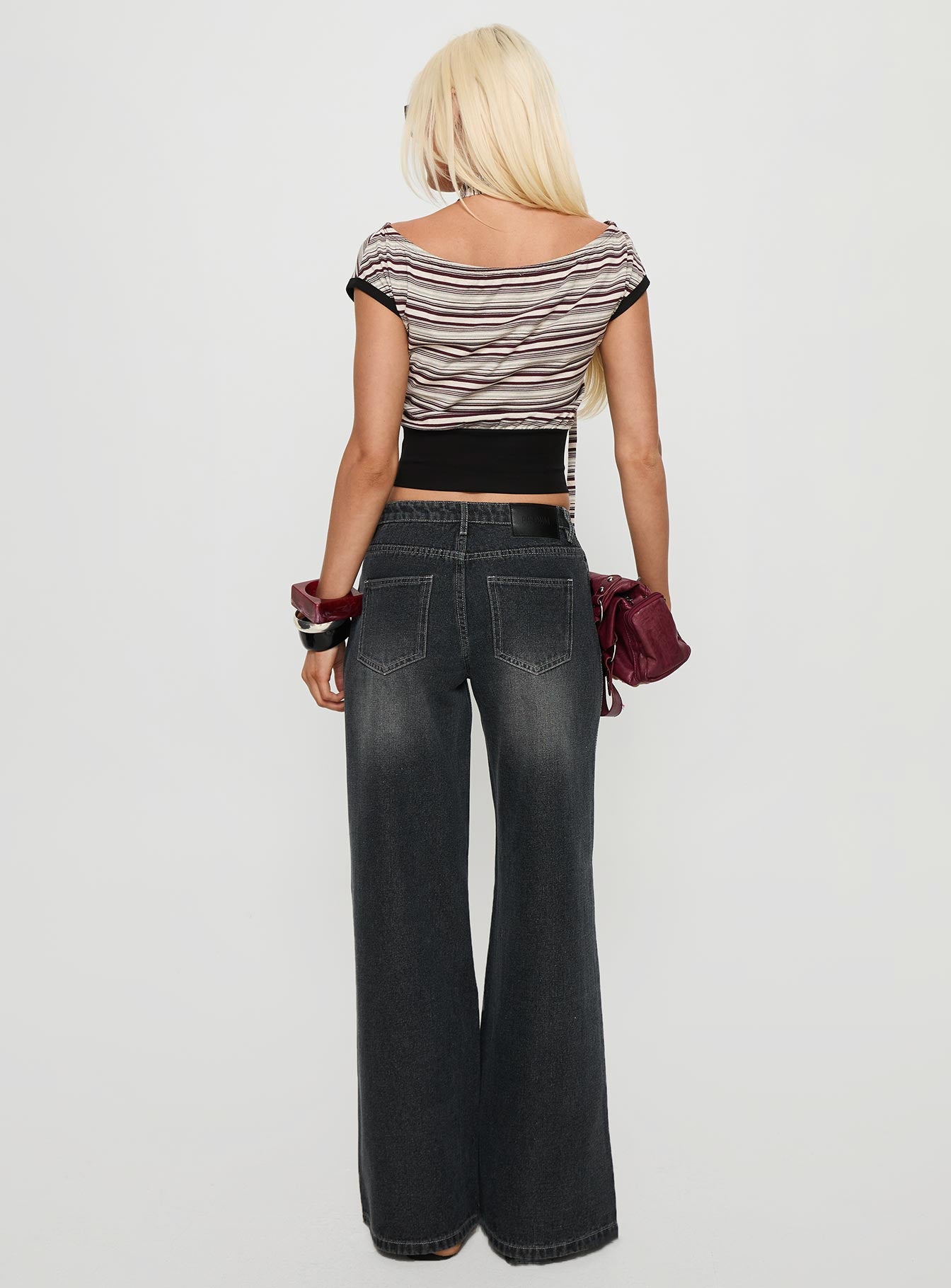 back view of model wearing Princess Polly Ramos Low Rise Wide Leg Jeans Dark Grey Wash Low Rise Jeans 