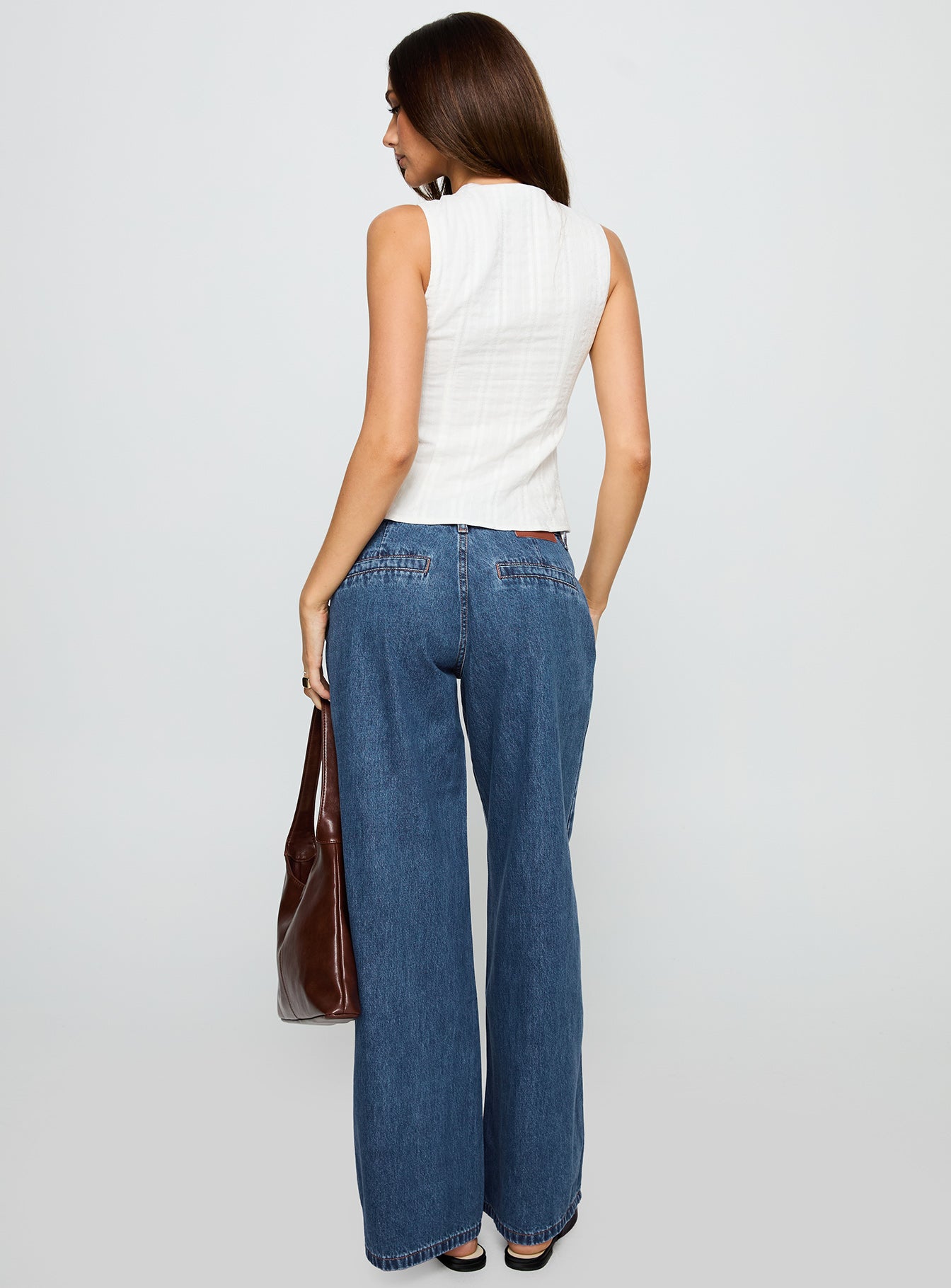 back view of model wearing Princess Polly Hyde Baggy Jeans Mid Blue Low Rise Jeans 