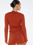 Long sleeve knit top, open front Scooped neckline, tie fastening at bust, flared cuff