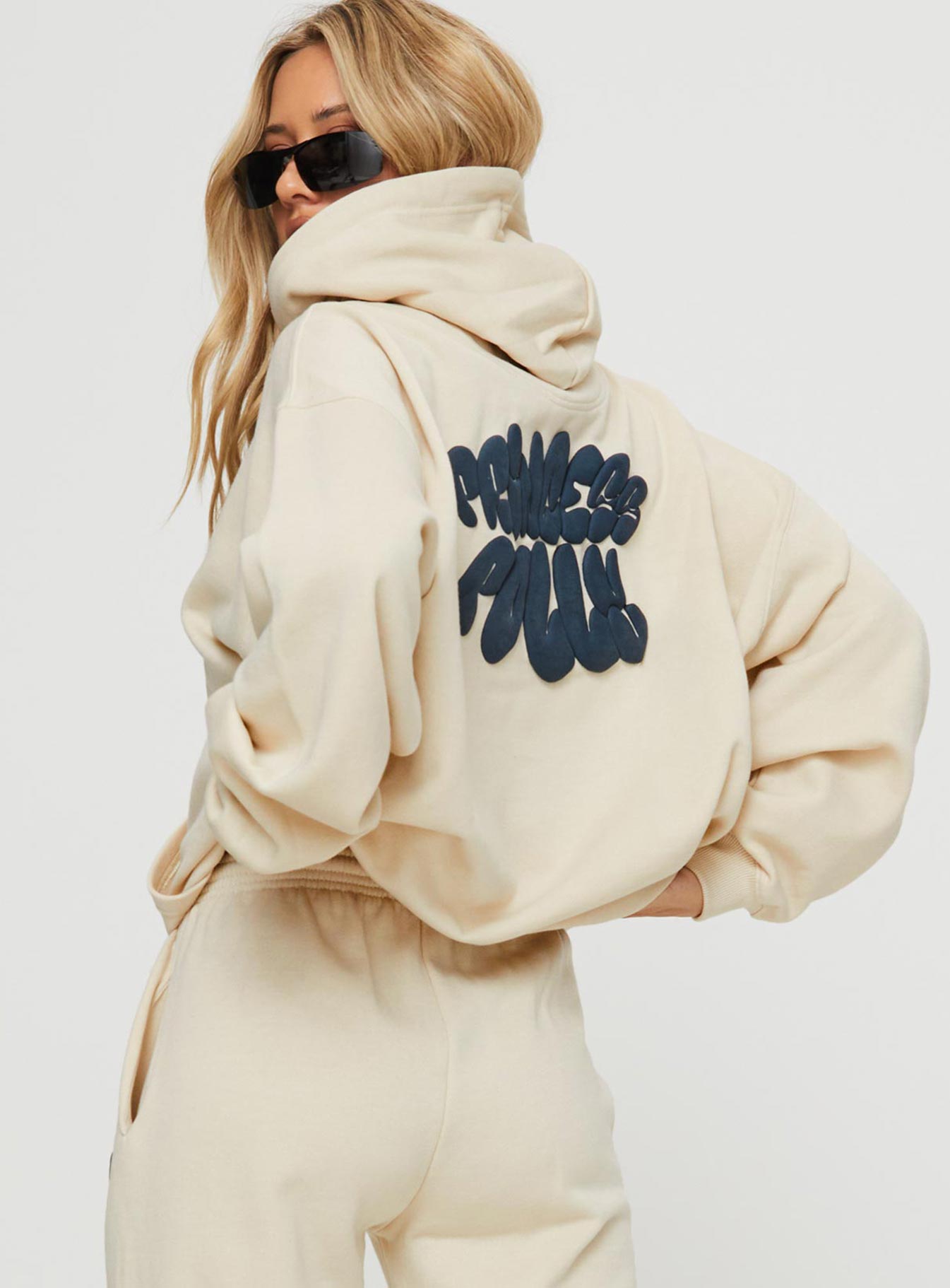 back view of model wearing Princess Polly Princess Polly Hooded Sweatshirt Bubble Text Stone / Slate Long 