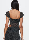 back view of model wearing Princess Polly District Top Onyx Polka Short Sleeves Square Neck 