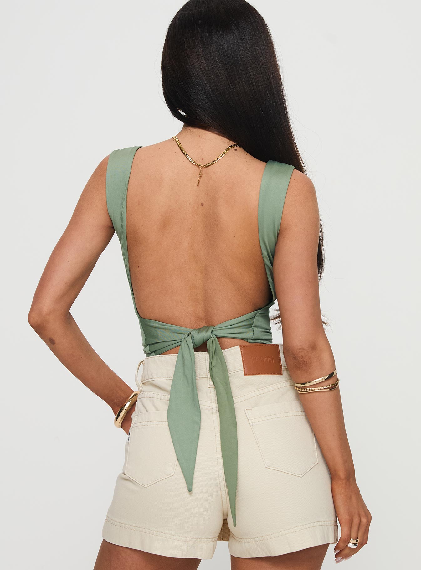 back view of model wearing Princess Polly Imelda Top Green Sleeveless Square Neck 